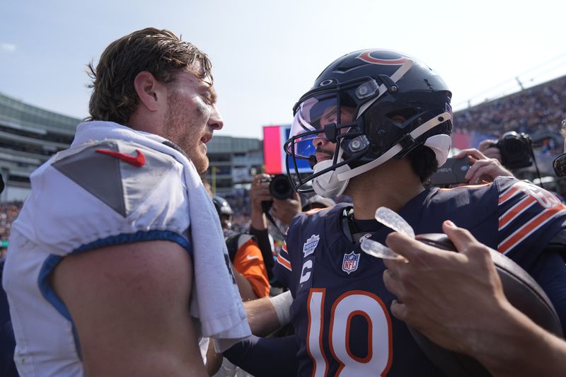 Tennessee Titans quarterback Will Levis and Chicago Bears quarterback Caleb Williams talk after the Bears' 24-17 win over the Titans in an NFL football game Sunday, Sept. 8, 2024, in Chicago. (AP Photo/Erin Hooley)