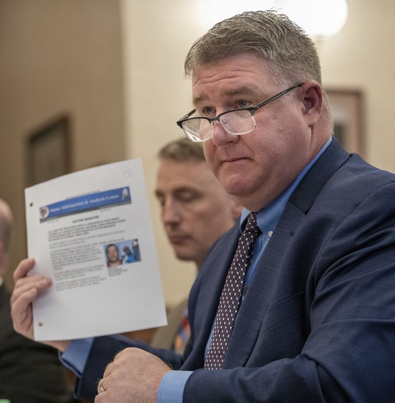 Maine State Police Col. William Ross holds up an internal document that was leaked to the media during the manhunt for Robert Card during a hearing at Lewiston City Hall, Friday, May 24, 2024 in Lewiston, Maine. (Russ Dillingham /Sun Journal via AP)