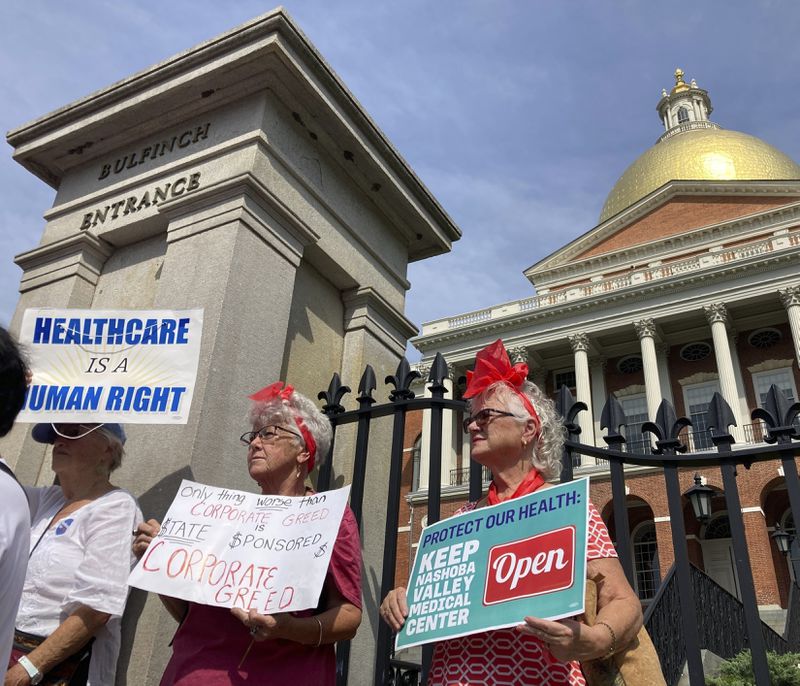 Protesters wanting to keep two Massachusetts hospitals open gather in front of the statehouse in Boston on Wednesday, Aug. 28, 2024. (AP Photo/Steve LeBlanc)