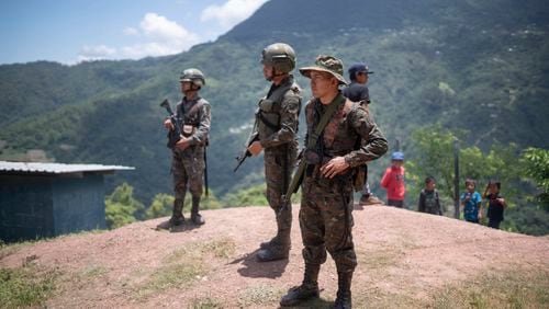 Guatemalan soldiers stand guard in Ampliación Nueva Reforma, Huehuetenango, Guatemala, where Mexicans from the town of Amatenango, Mexico fled due to cartel violence in their country across the border, Thursday, July 25, 2024. (AP Photo/Santiago Billy)