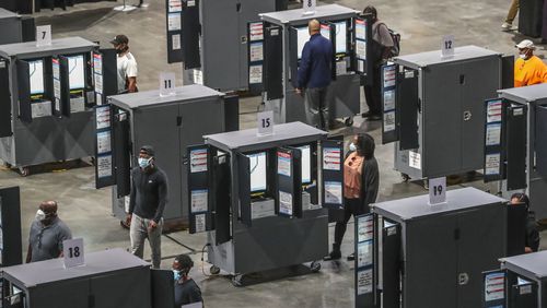 A year ago this week: Voters finally got to the machines after a glitch forestalled voting on Monday, Oct. 12, 2020 at State Farm Arena in downtown Atlanta. Eager Georgia voters swarmed to polling places Monday morning, waiting in lines created by high turnout and technical problems at the start of three weeks of early voting before Election Day. (John Spink / John.Spink@ajc.com)