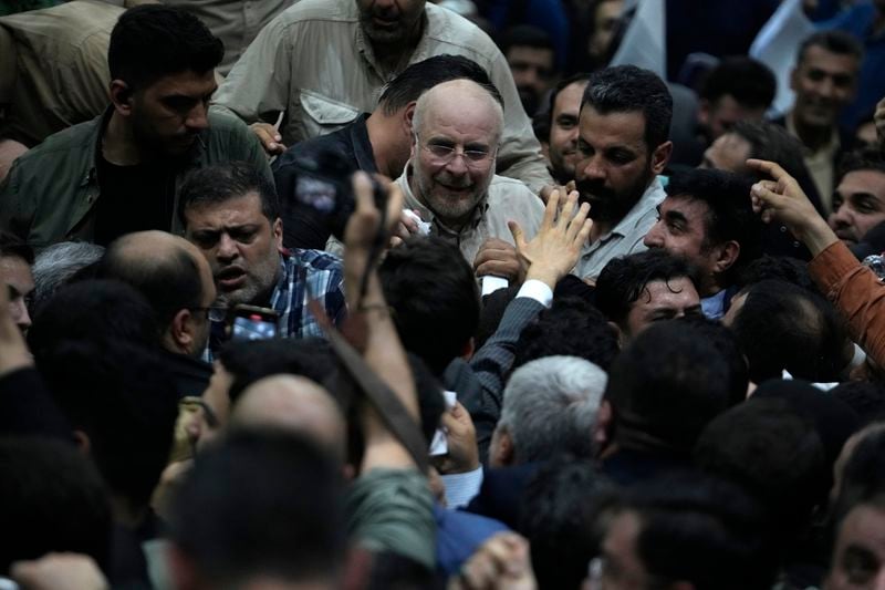 Iran's parliament speaker Mohammad Bagher Qalibaf, center, the most prominent hard-line candidate for the presidential election, leaves after speaking in his campaign gathering in Tehran, Iran, Wednesday, June 26, 2024. (AP Photo/Vahid Salemi)