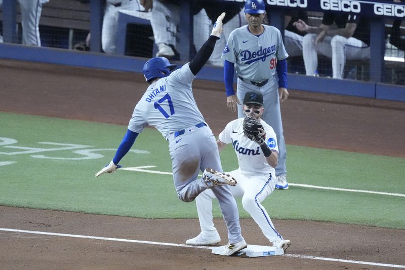 Los Angeles Dodgers' Shohei Ohtani (17) of Japan, steals third base as Miami Marlins third baseman Connor Norby attempts the tag during the first inning of a baseball game, Thursday, Sept. 19, 2024, in Miami. (AP Photo/Wilfredo Lee)