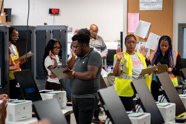 Elections employees get sworn in before beginning working. Dekalb County Elections officals conduct logic and accuracy testing of Dominion voting machines.  Monday, Sept. 16, 2024 (Ben Hendren for the Atlanta Journal-Constitution)