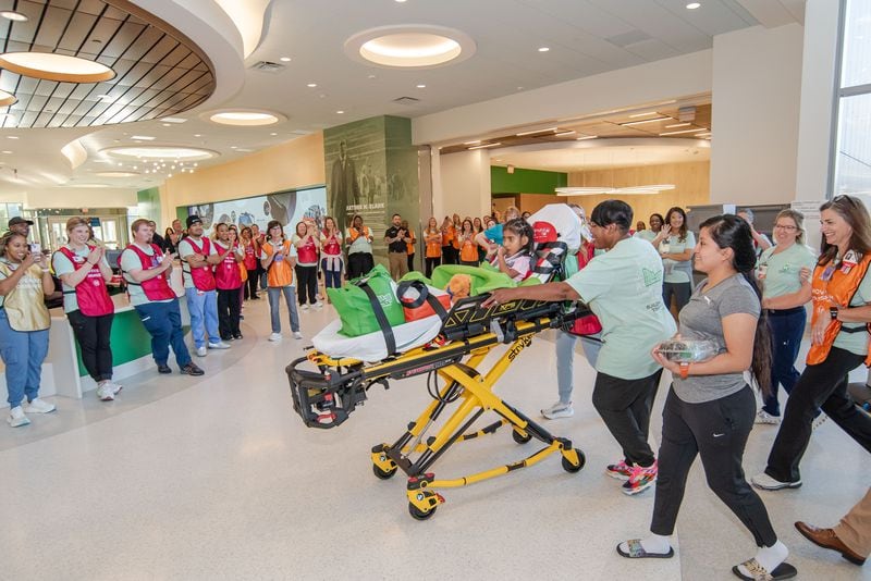 Eight-year-old Brithany Morales arrives to hospital workers' applause as the first-ever patient transferred to the brand-new Arthur M. Blank Hospital. Morales was the first patient to leave Egleston Hospital as it closed for good on Sunday, September 29, 2024, to be transferred to the brand-new Arthur M. Blank Hospital at I-85 and North Druid Hills Road.  Children's Healthcare of Atlanta hopes to move the entire Egleston patient population, hundreds of children, in one day, in ambulances one by one. (Photo courtesy of Children’s Healthcare of Atlanta)