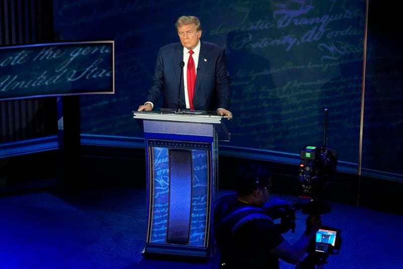 Republican presidential nominee former President Donald Trump waits at the podium during a break in the presidential debate with Democratic presidential nominee Vice President Kamala Harris at the National Constitution Center, Tuesday, Sept.10, 2024, in Philadelphia. (AP Photo/Alex Brandon)