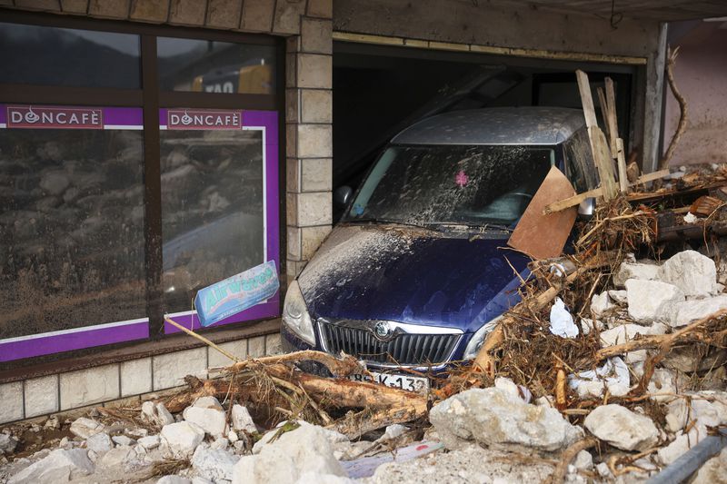 A damaged car is seen after flood hit the village of Donja Jablanica, Bosnia, Saturday, Oct. 5, 2024. (AP Photo/Armin Durgut)