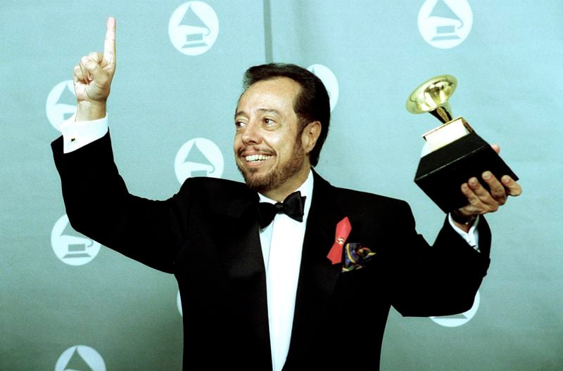 FILE - Sergio Mendes holds up his Gramophone trophy at the Grammy Awards show held at the Shrine Auditorium in Los Angeles, on Feb. 24, 1993. (AP Photo/Reed Saxon, File)