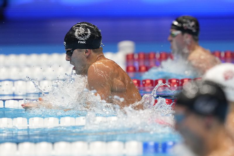 Nic Fink swims during the Men's 100 breaststroke finals Sunday, June 16, 2024, at the US Swimming Olympic Trials in Indianapolis. (AP Photo/Michael Conroy)