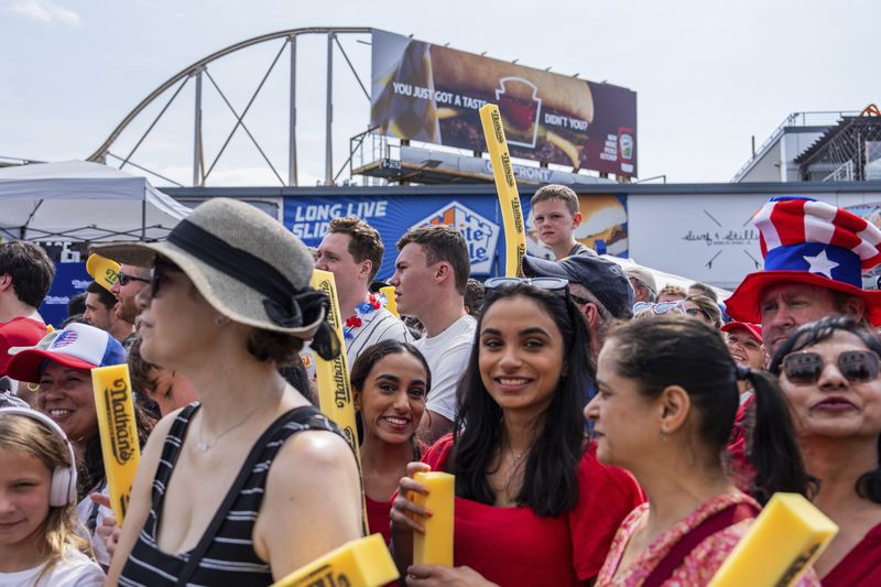 People wait for the start of Nathan's Famous Fourth of July hot dog eating contest, Thursday, July 4, 2024 at Coney Island in the Brooklyn borough of New York. (AP Photo/Julia Nikhinson)