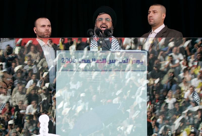 FILE - Hezbollah leader Hassan Nasrallah, center, speaks during the annual rally to mark Al-Quds Day, Jerusalem Day, in the southern suburbs of Beirut, Friday, Oct. 28, 2005. (AP Photo/Hussein Malla, File)