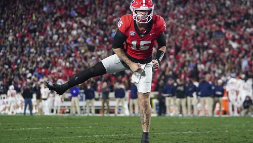 FILE - Georgia quarterback Carson Beck (15) reacts after a touchdown against Mississippi during the first half of an NCAA college football game, Saturday, Nov. 11, 2023, in Athens, Ga. (AP Photo/John Bazemore, File)