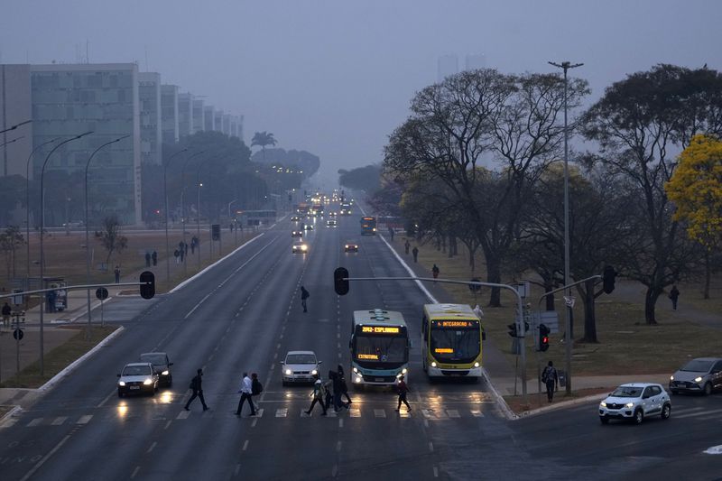 Smoke from wildfires hovers over the city amid dry weather in Brasilia, Brazil, early Monday, Aug. 26, 2024. (AP Photo/Eraldo Peres)