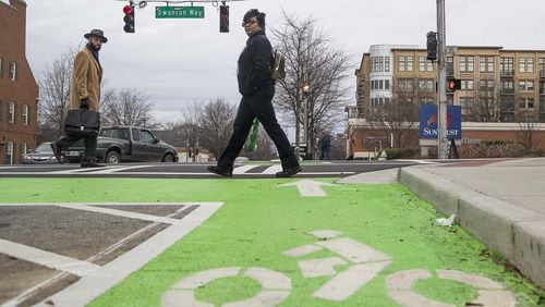 Pedestrians cross the intersection of Commerce Drive and Swanton Way in downtown Decatur, Thursday, January 23, 2020. The city renovated the sidewalks adding enough space for a bicycle lane in addition to foot traffic. (ALYSSA POINTER/ALYSSA.POINTER@AJC.COM)