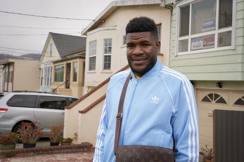 Cabrel Ngougou, a refugee from Cameroon, poses for a photo in San Francisco Tuesday, Sept. 17, 2024. (AP Photo/Terry Chea)