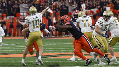 Georgia Tech quarterback Haynes King, left, is pressured Syracuse defensive lineman Fadil Diggs (10) during the second half of an NCAA football game on Saturday, Sept. 7, 2024, in Syracuse, N.Y. Syracuse won 31-28. (AP Photo/Hans Pennink)