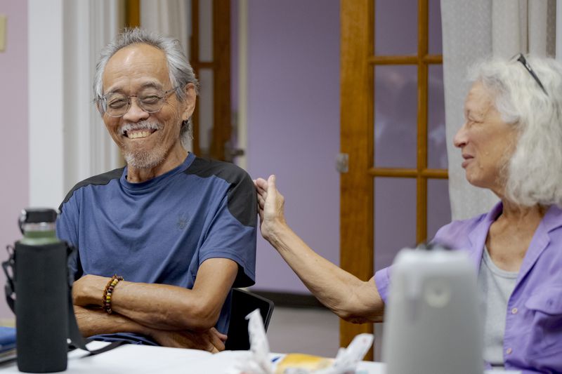 Frank Aseron, left, gets a pat on the back from Lucille Stand for delivering 50 meals and portable battery power to fellow senior citizens during Hurricane Francine earlier in the month as part of the Community Lighthouse initiative at First Grace United Methodist Church in New Orleans, Wednesday, Sept. 25, 2024. (AP Photo/Matthew Hinton)