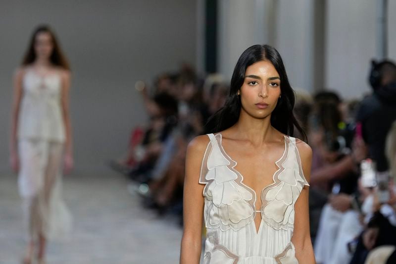 A model wears a creation as part of the Alberta Ferretti Spring Summer 2025 collection, that was presented in Milan, Italy, Tuesday, Sept. 17, 2024. (AP Photo/Luca Bruno).