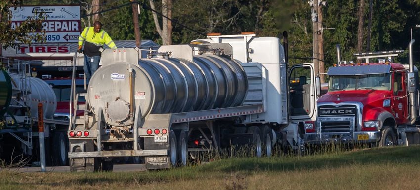 Trucks staged outside of BioLab as seen from Old Covington Hwy on Thursday, Oct. 3, 2024 in Conyers. A Sunday fire at the chemical plant in Conyers has had agencies monitoring the air quality since then as crews try to neutralize the site. Rockdale County officials said that the plume is changing colors as workers remove debris. GEMA has advised anyone who notices a chlorine odor in the air to limit their time outdoors. (John Spink/AJC)