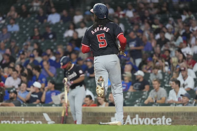 Washington Nationals' CJ Abrams (5) scores on a single by Andrés Chaparro during the first inning of a baseball game against the Chicago Cubs, Thursday, Sept. 19, 2024, in Chicago. (AP Photo/Erin Hooley)