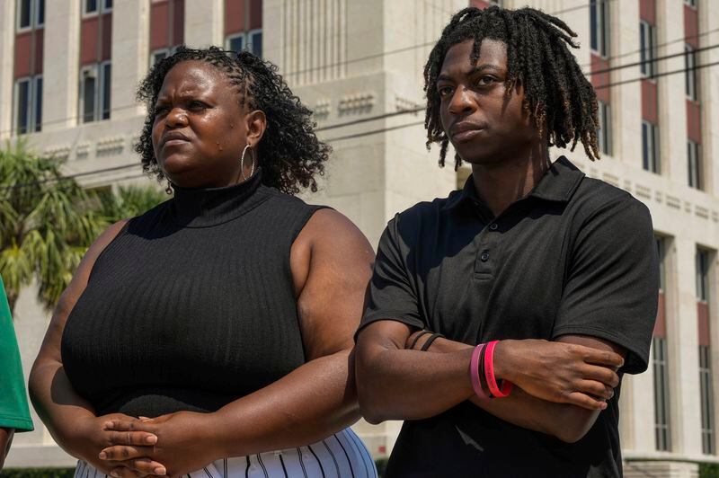 Darryl George,18, stands next to his mother, Darresha George in front of Galveston County Court House on Thursday, May 23, 2024, in Galveston, Texas. A hearing was set to be held Thursday in a federal lawsuit a George filed against his Texas school district over his punishment for refusing to change his hairstyle. (Raquel Natalicchio/Houston Chronicle via AP)