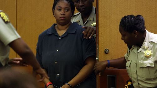 Danielle Parker is led into Fulton County Judge Karen Woodson's courtroom on Wednesday July 31, 2013, for a probable cause hearing in the murder of East Point Police Officer Crystal Parker.
