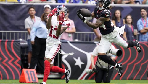 Houston Texans cornerback Derek Stingley Jr. (24) intercepts a pass intended for New York Giants wide receiver Jalin Hyatt (13) that was thrown by quarterback Daniel Jones (8) in the first half of a preseason NFL football game, Saturday, Aug. 17, 2024, in Houston. (AP Photo/Eric Christian Smith)