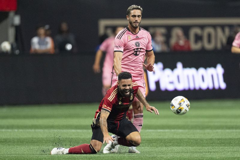 Atlanta United defender Derrick Williams (3) and Inter Miami forward Leonardo Campana (8) chase the ball during thre first half of a MLS soccer match Wednesday, Sept. 18, 2024. (AP Photo/John Bazemore)