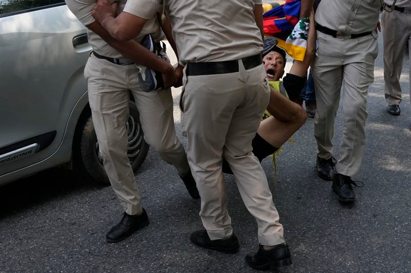 Policemen detain an exile Tibetan protesting against the human rights situation in Tibet during a protest to coincide China marking its 75th year of Communist Party rule, outside Chinese embassy, in New Delhi, India, Tuesday, Oct. 1, 2024. (AP Photo/Manish Swarup)