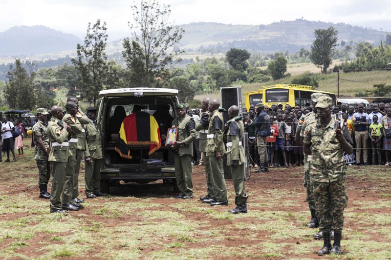 Members of the Uganda People's Defense Force carry the casket of Ugandan Olympic athlete Rebecca Cheptegei ahead of her burial in Kapkoros, Bukwo District, Uganda, on Saturday, Sept. 14. 2024. (AP Photo/Hajarah Nalwadda)