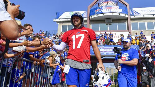 Quarterback Josh Allen (17) greets fans as he walks to the field during an NFL football training camp practice in Pittsford, N.Y., Wednesday, July 24, 2024. (AP Photo/Adrian Kraus)