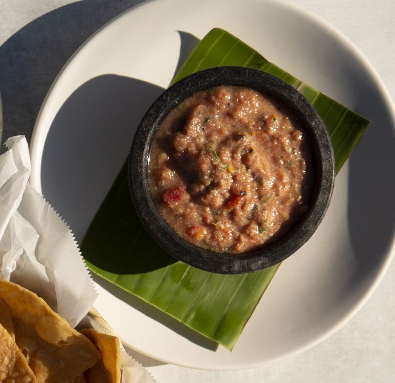 Sikil Pak is a rustic, spicy salsa based on an ancient Mayan recipe made of charred tomatoes and toasted pumpkin seeds that is served with chips at La Semilla restaurant in the Reynoldstown neighborhood. (Courtesy of Martha Williams / La Semilla)