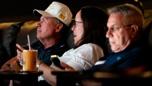 Attendees watch the Republican National Convention on Thursday from the Springs Cinema & Taphouse in Sandy Springs. The event was sponsored by the Republican parties in Cobb, DeKalb, Fulton and Gwinnett counties. (Seeger Gray / AJC)