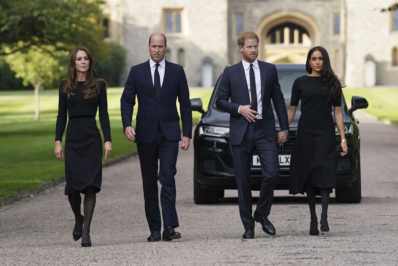 FILE - From left, Kate, the Princess of Wales, Prince William, Prince of Wales, Prince Harry and Meghan, Duchess of Sussex walk to meet members of the public at Windsor Castle, following the death of Queen Elizabeth II on Thursday, in Windsor, England, Saturday, Sept. 10, 2022. (Kirsty O'Connor/Pool Photo via AP, File)