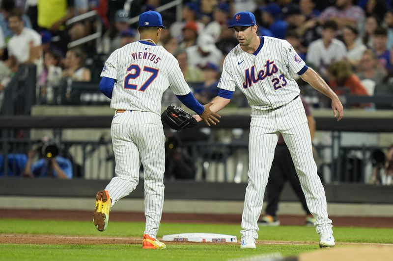 New York Mets pitcher David Peterson, right, celebrates with Mark Vientos (27) after Vientos made a catch to end the top of the fourth inning of a baseball game against the Baltimore Orioles at Citi Field, Monday, Aug. 19, 2024, in New York. (AP Photo/Seth Wenig)