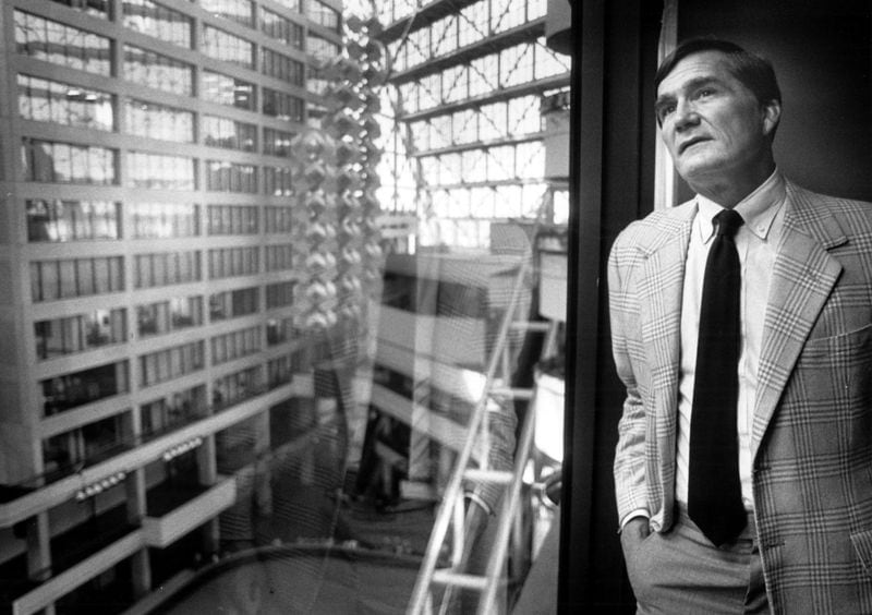 Tom Cousins, president of Cousins Properties, looks out onto the Omni atrium from his office in the north tower in July 1983. (Andy Sharp/AJC staff)