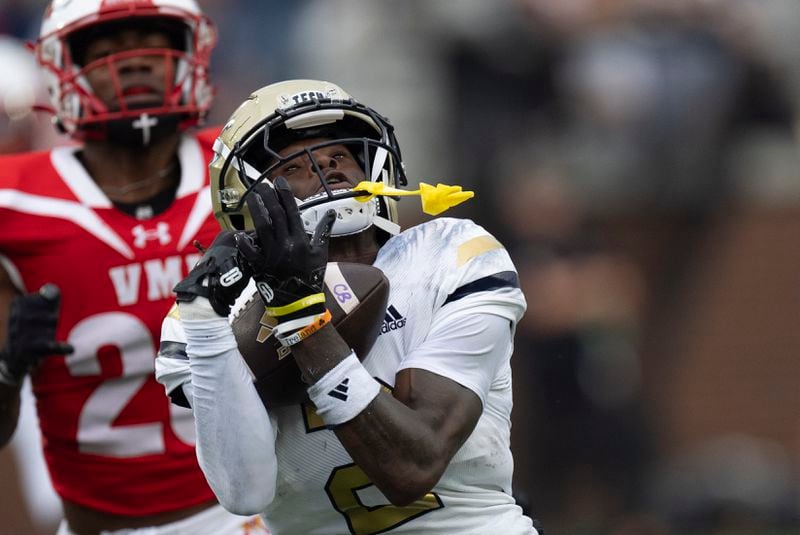 Georgia Tech wide receiver Eric Singleton Jr. (2) makes a catc for a first down as Virginia Military Institute safety Isaiah Grevious (28) defends during the first half of a NCAA college football game Sunday, Sept. 14, 2024, in Atlanta,. (AP Photo/John Bazemore)