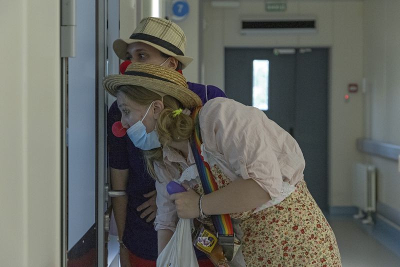 Vladyslava Kulinich, rear, and Tetiana Nosova, who have the clown names Lala and Zhuzha, prepare to perform at Okhmatdyt children's hospital in Kyiv, Ukraine, Thursday Sept. 19, 2024. (AP Photo/Anton Shtuka)