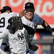 New York Yankees center fielder Aaron Judge, right, celebrates with Juan Soto, front, and Jasson Dominguez (89) after a baseball game against the Boston Red Sox, Sunday, Sept. 15, 2024, in New York. (AP Photo/Adam Hunger)