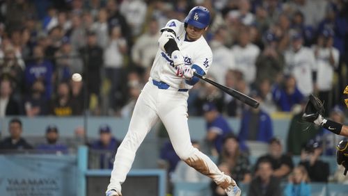 Los Angeles Dodgers' Shohei Ohtani hits an RBI single during the seventh inning of a baseball game against the San Diego Padres, Thursday, Sept. 26, 2024, in Los Angeles. (AP Photo/Ashley Landis)