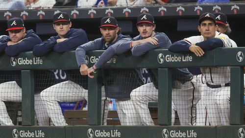 Kyle Wright (second from left), Charlie Culberson (third from left) and Max Fried (second from right) watch the Braves bat during the seventh inning against the Los Angeles Dodgers at Truist Park, Tuesday, May 23, 2023, in Atlanta. Starting pitchers Wright and Fried are on the disabled list. (Jason Getz / Jason.Getz@ajc.com)