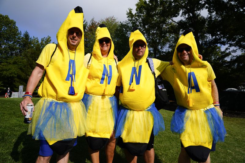 Fans wear costumes during a Solheim Cup golf tournament singles match at the Robert Trent Jones Golf Club, Sunday, Sept. 15, 2024, in Gainesville, Va. (AP Photo/Chris Szagola)