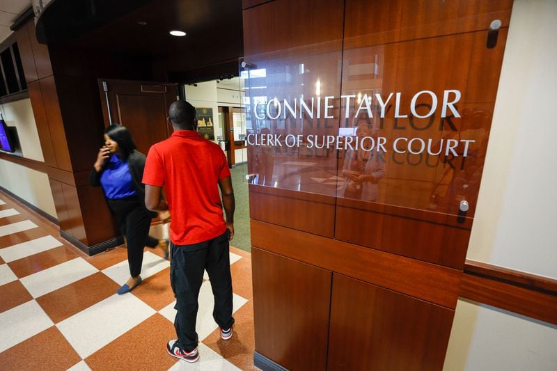 People are spotted entering and exiting the clerk’s office at the Cobb County Superior Court on Thursday, August 8, 2024. Chief Judge Gregory Poole issued a 30-day emergency order on Wednesday that suspends filing deadlines and other administrative requirements in civil and criminal cases.(Miguel Martinez / AJC)