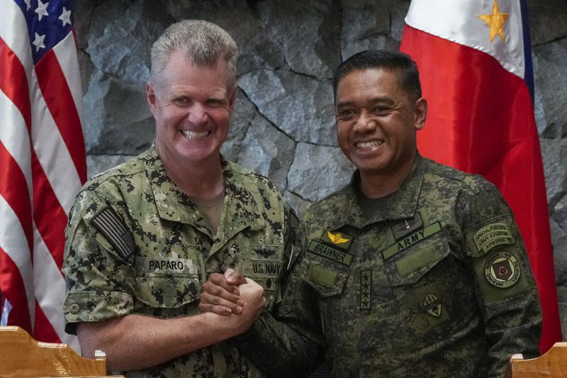 U.S. Indo-Pacific Command Commander Admiral Samuel Paparo, left, and Philippines military chief Gen. Romeo Brawner Jr., shake hands after a press conference on the Mutual Defense Board-Security Engagement Board held at the Philippine Military Academy in Baguio, northern Philippines on Thursday, Aug. 29, 2024. (AP Photo/Aaron Favila)