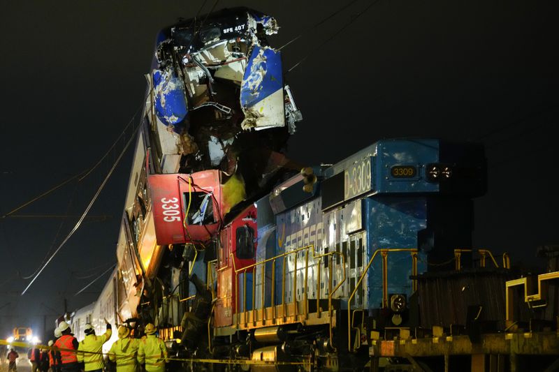 Police inspect two trains that collided in San Bernardo, Santiago, Chile, Thursday, June 20, 2024. (AP Photo/Esteban Felix)