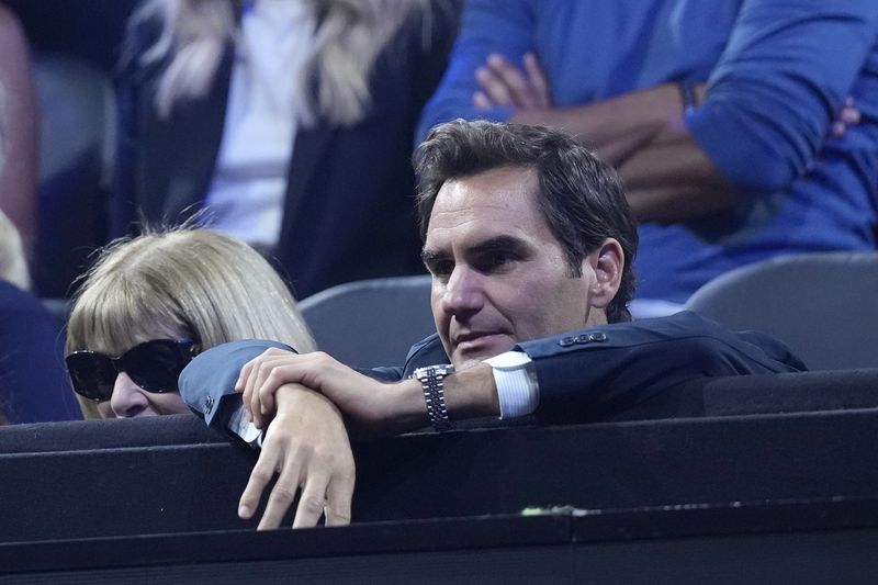 Tennis great Roger Federer follows the game during the doubles match between Team Europe's Carlos Alcaraz and Casper Ruud and Team World's Frances Tiafoe and Ben Shelton on the third day of the Laver Cup tennis tournament, at the Uber arena in Berlin, Germany, Sunday, Sept. 22, 2024. (AP Photo/Ebrahim Noroozi)