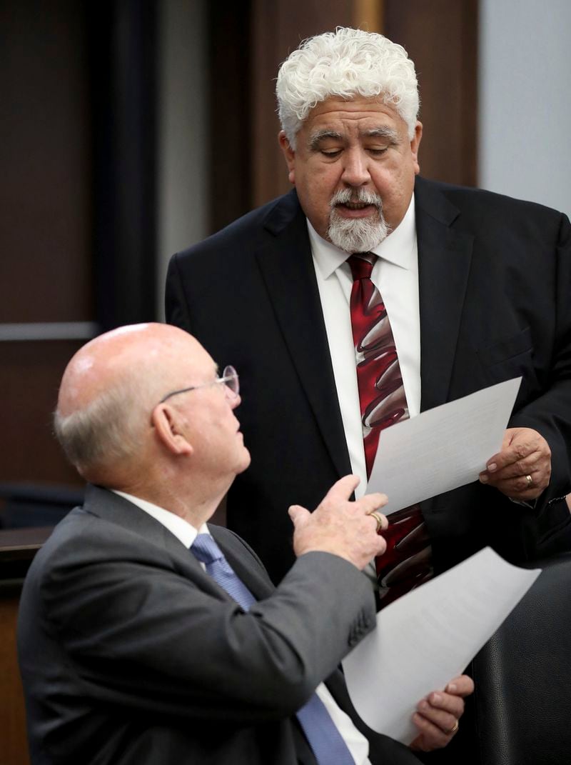 Plaintiff's attorney Alton Todd, seated, speaks with Roberto Torres, the court-assigned civil attorney for accused Santa Fe High School shooter Dimitrios Pagourtzis, in Galveston District Court No. 3 Judge Jack Ewing's courtroom in Galveston County Circuit Court in Galveston, Texas, on Friday, Aug. 16, 2024. (Jennifer Reynolds/The Galveston County Daily News via AP, Pool)