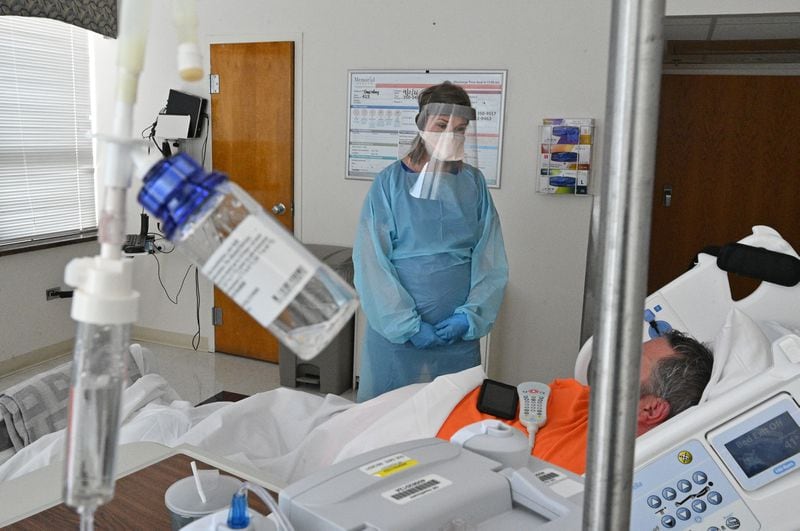 In this file photo, registered ICU nurse Katie Van Hook checks on a COVID-19 patient at Memorial Health's Heart and Vascular Institute in Savannah. (Hyosub Shin / Hyosub.Shin@ajc.com)