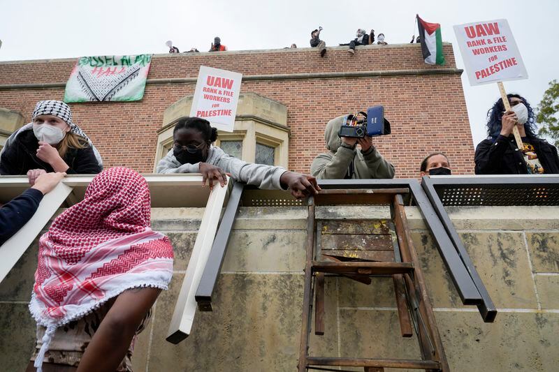 Pro-Palestinian demonstrators gather on the campus of UCLA in Los Angeles, Thursday, May 23, 2024. (AP Photo/Damian Dovarganes)