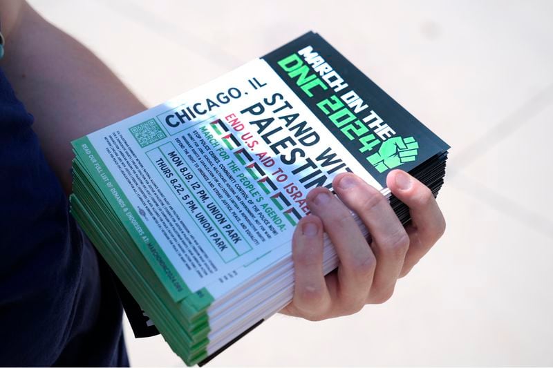 Activist Liz Rathburn holds flyers on the University of Illinois-Chicago campus Wednesday, Aug. 14, 2024, about two marches in support of Palestine, during the Democratic National Convention next week in Chicago. (AP Photo/Charles Rex Arbogast)